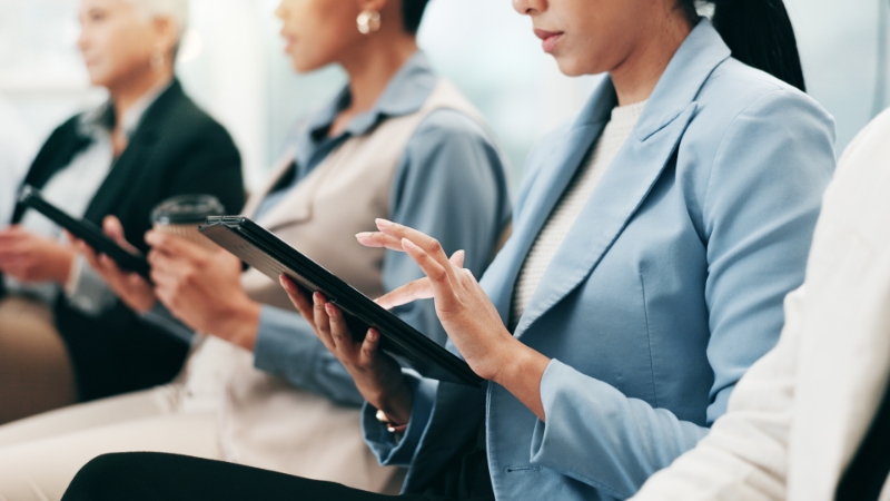 women at a workshop using their tablets
